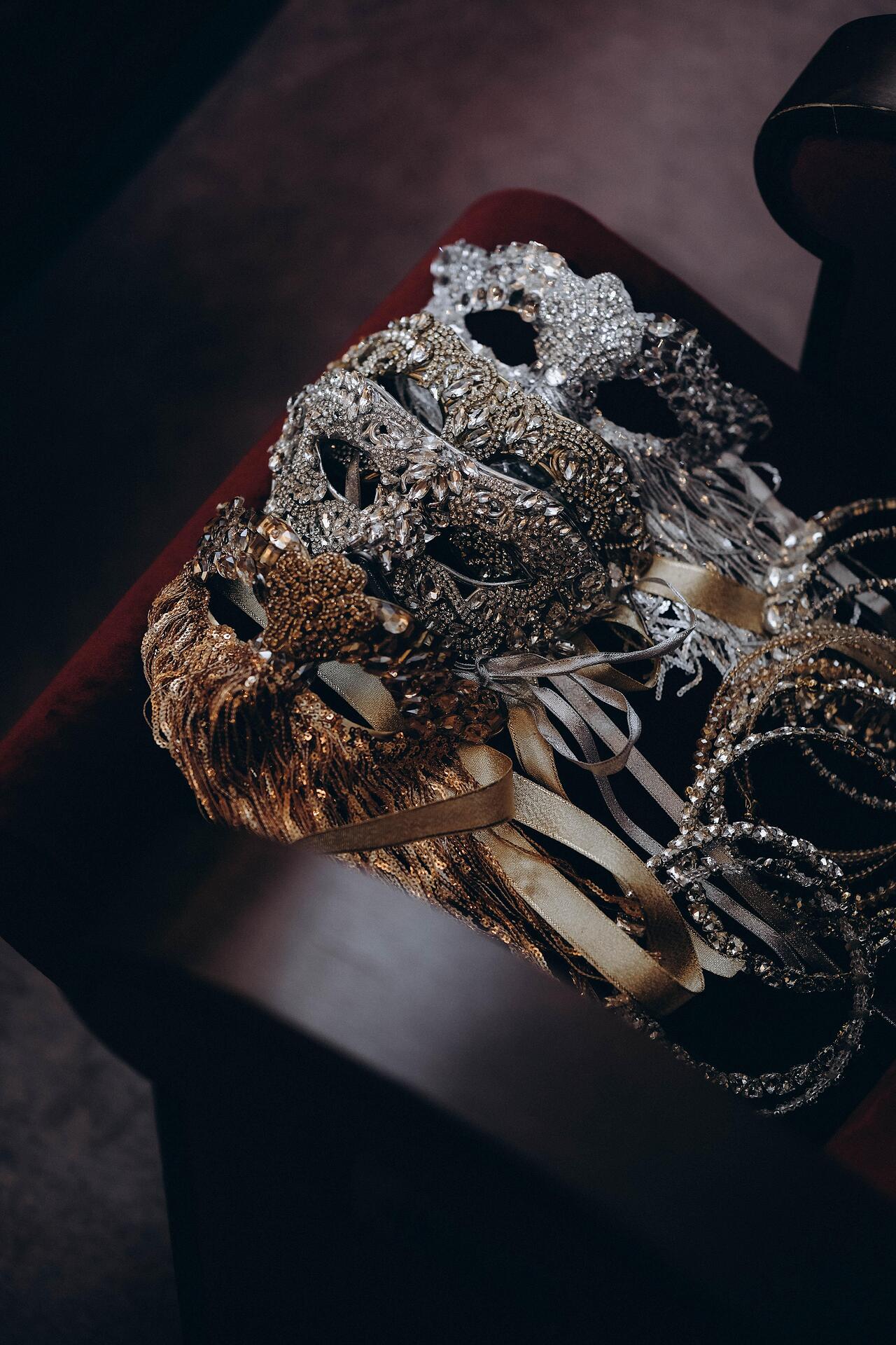 Silver mask with stones and hanging threads: Beyond