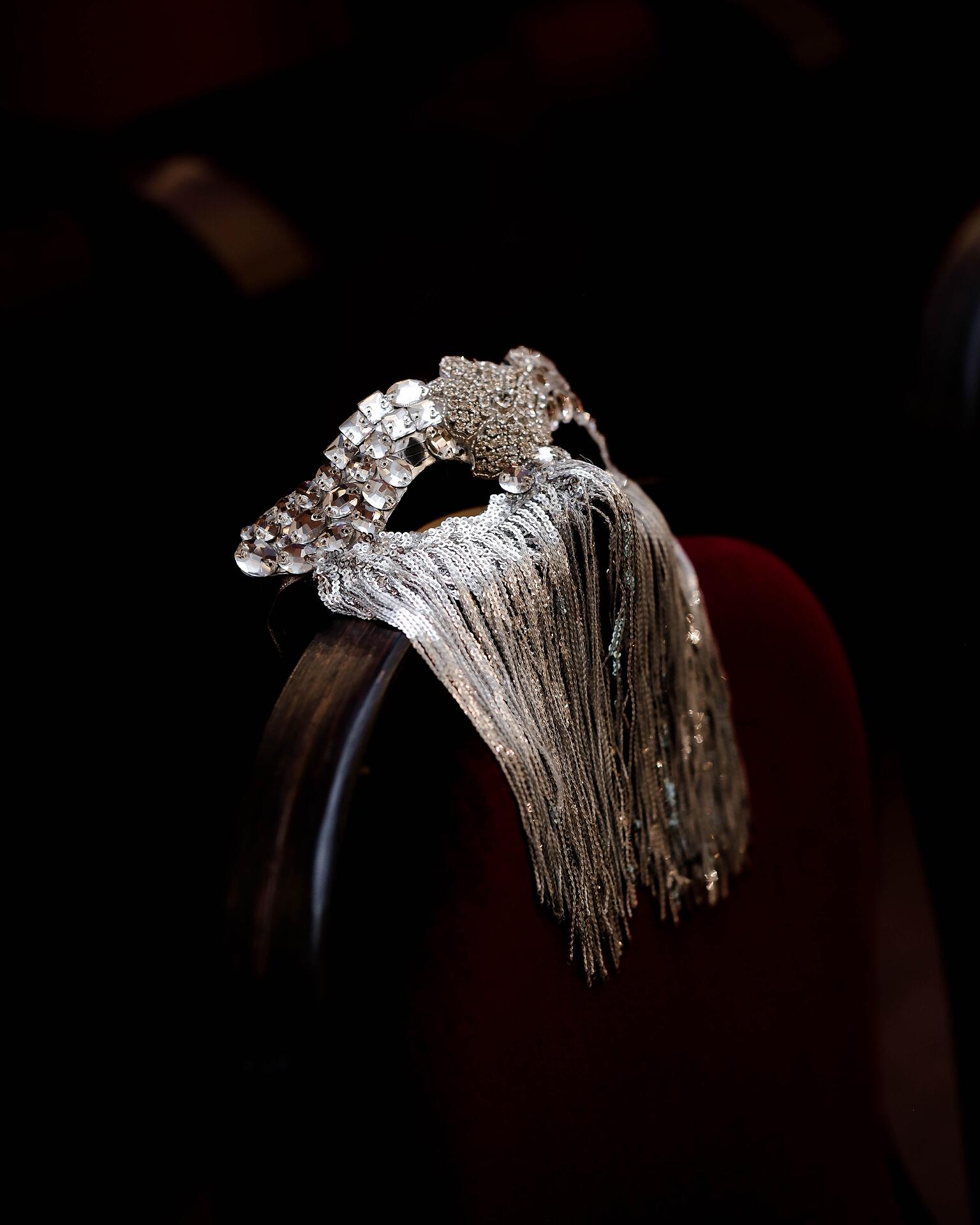 Silver mask with stones and hanging threads: Beyond