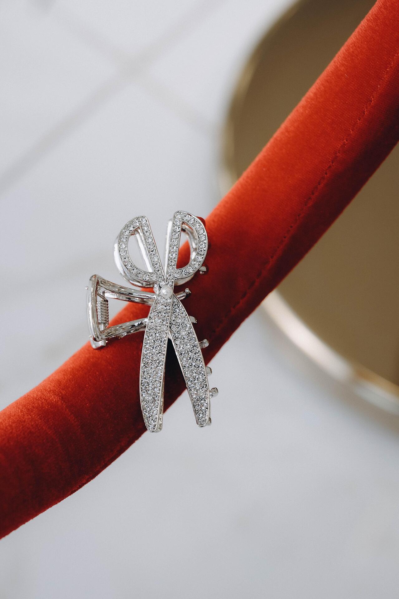 Silver scissor-shaped hair clip